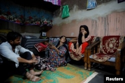 Muskan,16, smiles as she talks to her parents, Tofik and Nasreen, at their residence in Loni town in the northern state of Uttar Pradesh, India, Sept. 18, 2024.