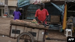 FILE - A vendor sells goods outside a market in Niger on August 14, 2023. 