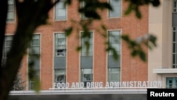 FILE - Signage is seen outside of the Food and Drug Administration (FDA) headquarters in White Oak, Maryland, August 29, 2020. 