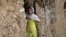 An Afghan refugee girl outside her home in slums of Islamabad, Pakistan, May 16, 2012.