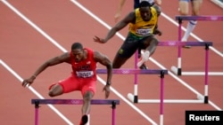 Michael Tinsley of the U.S. (L) and Jamaica's Leford Green clear hurdles during the men's 400m hurdles in London in 2012. 