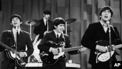 FILE - The Beatles perform on CBS' "Ed Sullivan Show" in New York, Feb. 9, 1964.