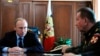 FILE - Russian President Vladimir Putin, left, and Commander-in-Chief of the Interior Ministry troops Viktor Zolotov attend a meeting in the Kremlin in Moscow, Russia, April 5, 2016.