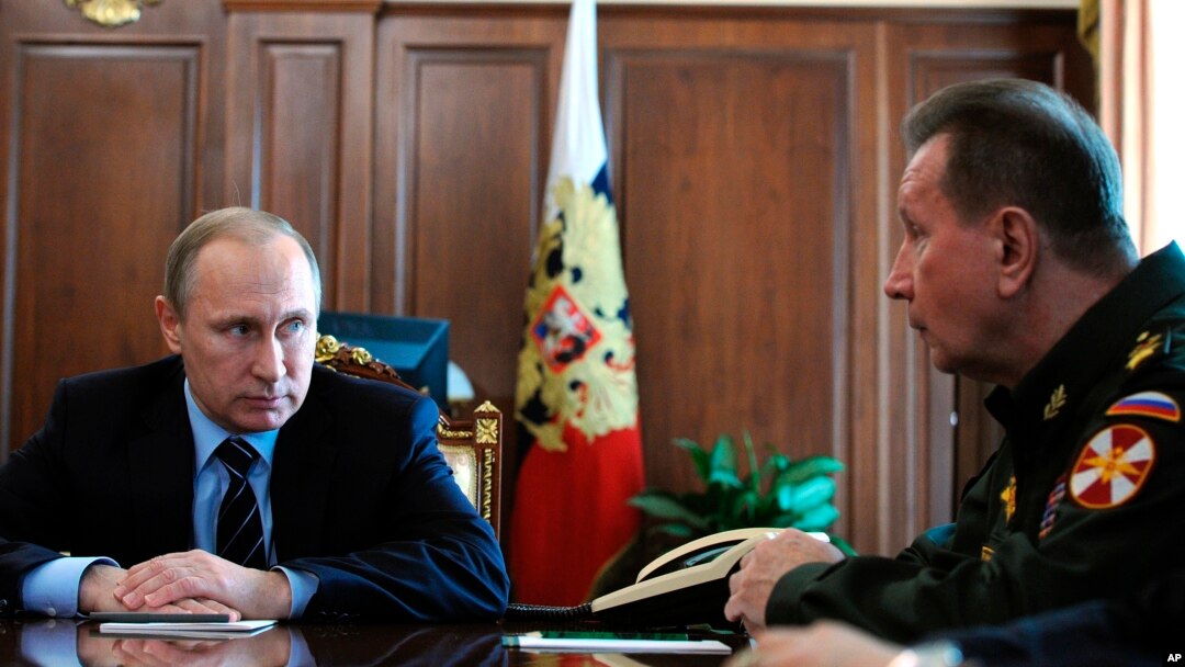 FILE - Russian President Vladimir Putin, left, and Commander-in-Chief of the Interior Ministry troops Viktor Zolotov attend a meeting in the Kremlin in Moscow, Russia, April 5, 2016.