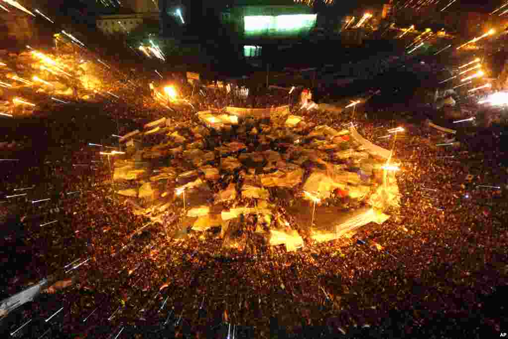 Egyptians in Tahrir square celebrate after President Hosni Mubarak resigned and handed power to the military at Tahrir Square, Feb. 11, 2011.