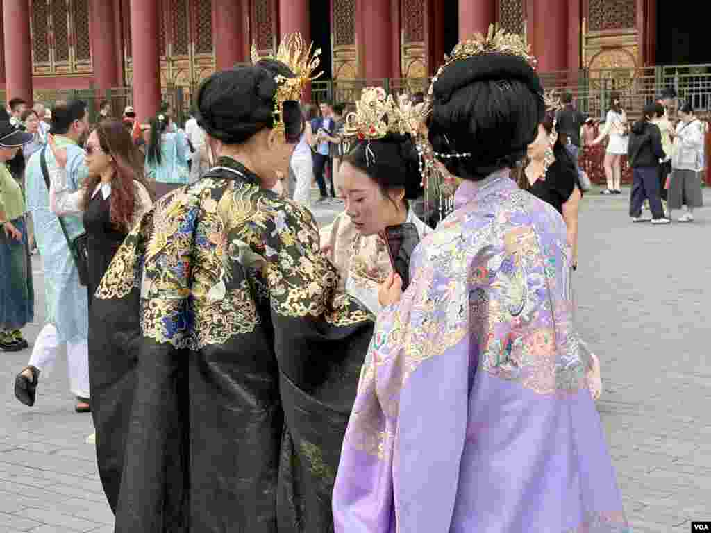 Chinese woman wearing traditional style dresses in the Forbidden City.