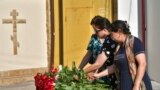 Women lay flowers at a makeshift memorial in front of the Holy Assumption Cathedral after an attack by Islamic militants in Makhachkala, Republic of Dagestan, Russia, on June 24, 2024. (AP)