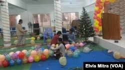 Christians are busy decorating a church in Dhaka, Bangladesh, Dec. 24, 2015, ahead of the late afternoon Christmas Eve mass.