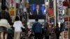 A screen shows a broadcast of President-elect Joe Biden speaking, Nov. 8, 2020, at the Shinjuku shopping district in Tokyo, Japan.