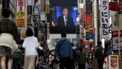 FILE - A screen shows a broadcast of then-President-elect Joe Biden speaking, Nov. 8, 2020, at the Shinjuku shopping district in Tokyo, Japan.