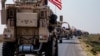 FILE - U.S. military convoy drives near the town of Qamishli, northern Syria, Oct. 26. 2019. 