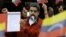 FILE - Venezuela's President Nicolas Maduro shows a document with the details of a "constituent assembly" to reform the constitution during a rally at Miraflores Palace in Caracas, Venezuela, May 23, 2017.