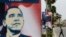 Palestinian man walks near placards designed by an activist depicting U.S. President Barack Obama ahead of his visit to the region, in the West Bank city of Ramallah.