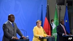 FILE —German Chancellor Angela Merkel, center, at a press conference with Felix Tshisekedi, President of the Democratic Republic of the Congo, left, and Cyril Ramaphosa, President of the South African Republic after the "G20 Compact with Africa" meeting in Berlin, Aug. 27, 2021