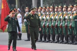 FILE - Russian Defense Minister Sergei Shoigu and his Vietnamese counterpart Ngo Xuan Lich (L) review an honor guard during a welcoming ceremony for Shoigu at the Ministry of Defense in Hanoi, Vietnam, Jan. 23, 2018.