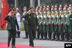 FILE - Russian Defense Minister Sergei Shoigu and his Vietnamese counterpart Ngo Xuan Lich (L) review an honor guard during a welcoming ceremony for Shoigu at the Ministry of Defense in Hanoi, Vietnam, Jan. 23, 2018.