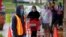 Doorman Dilon Moore controls the number of customers allowed to shop at one time at a Trader Joe's supermarket in Omaha, Nebraska, May 7, 2020.