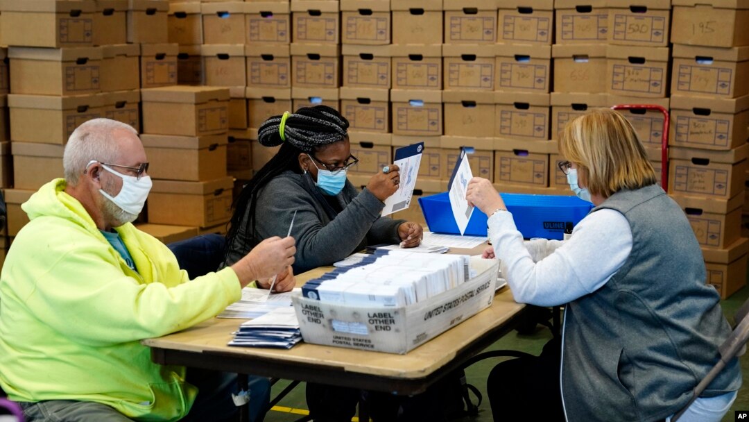 Chester County, Pa., election workers process mail-in and absentee ballots for the 2020 general election in the United States at West Chester University, Wednesday, Nov. 4, 2020, in West Chester., Pa. (AP Photo/Matt Slocum)