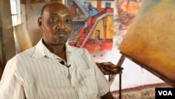 Kenyan artist Joseph Mbatia, known as "Bertiers," in his Nairobi studio, where he is working on a piece depicting a nationwide doctors' strike that has been ongoing for almost two months, Jan. 27, 2017. (VOA/J. Craig)