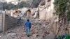 A Lebanese man walks past destroyed homes following a targeted Israeli air strike in the southern Lebanese village of Khiam, near the Lebanese-Israeli border, on June 21, 2024.