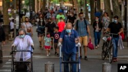People walk on a street in Barcelona, May 25, 2020.