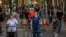 People walk on a street in Barcelona, May 25, 2020.