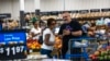 FILE - Shoppers pause in the produce section at a Walmart Superstore in Secaucus, New Jersey, July 11, 2024. 