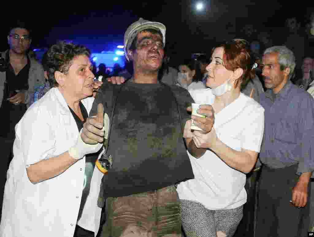 Medics help a rescued miner after a deadly explosion and fire at a coal mine in Soma, western Turkey, May 13, 2014.