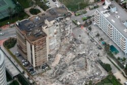 This aerial photo shows part of the 12-story oceanfront Champlain Towers South Condo that collapsed in Surfside, Fla., June 24, 2021. (Amy Beth Bennett /South Florida Sun-Sentinel via AP)
