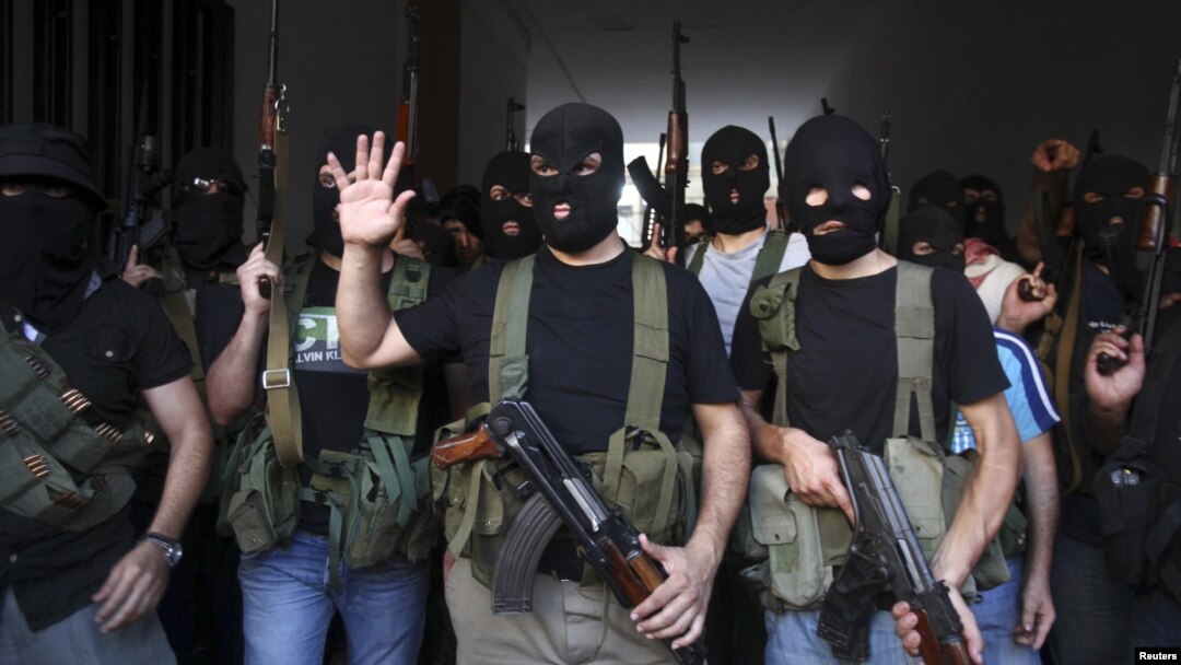 Shi'ite masked gunmen from the Mekdad clan gather at the Mekdad family's association headquarters in the southern suburbs in Beirut, Lebanon, August 15, 2012.