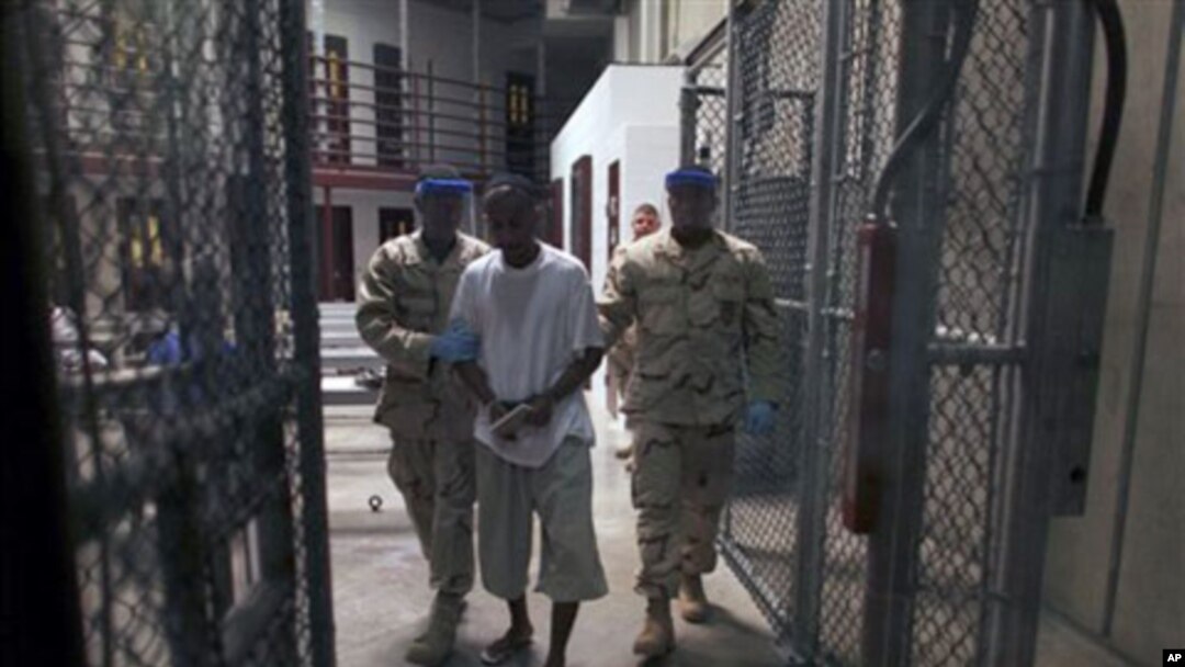 Detainee is escorted by guards inside Camp 6, a high-security detention facility at Guantanamo Bay U.S. Naval Base, Cuba., 30 Mar 2010 (file photo).