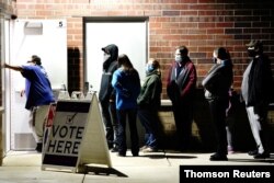 Voters wait in line to enter a polling station in Racine, Wisconsin, Nov. 3, 2020.