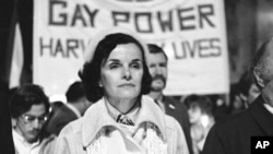 FILE - San Francisco Mayor Dianne Feinstein carries a candle as she leads an estimated 15,000 marchers also carrying candles during a march in memory of slain Mayor George Moscone and Supervisor Harvey Milk in San Francisco, Nov. 28, 1979.