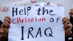 An Iraqi Christian who lives in Lebanon holds a placard during a sit-in, in front of the United Nations. (File)