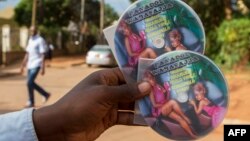 FILE - A vendor displays CDs featuring Ugandan pop singer Jemimah Kansiime, also known as “Panadol wa bassajja” - literally, "medicine for men" - in Kampala, Uganda, April 17, 2015. The singer was indicted under an anti-pornography law.