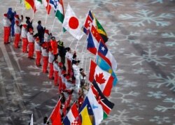 FILE - Flag bearers from various nations attend the closing ceremony of the 2018 Winter Olympics in Pyeongchang, South Korea, Feb. 25, 2018.