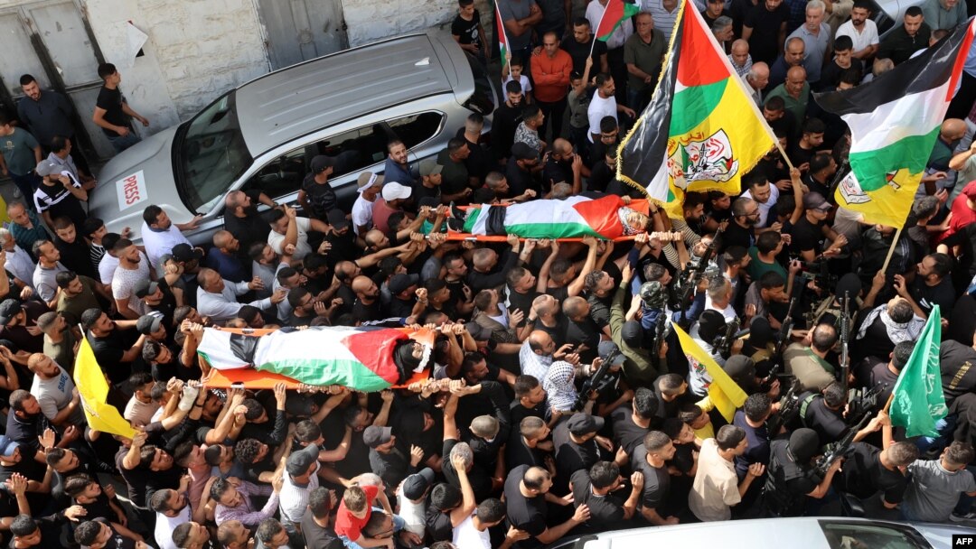 Mourners carry the bodies two Palestinian men that were killed during a raid on the village of Zawata, in the Israeli occupied West Bank on October 23, 2023.