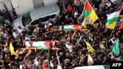 Mourners carry the bodies two Palestinian men that were killed during a raid on the village of Zawata, in the Israeli occupied West Bank on October 23, 2023.