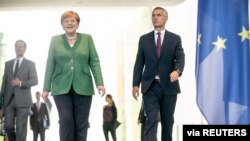 German Chancellor Angela Merkel and NATO Secretary General Jens Stoltenberg arrive at chancellery in Berlin, Germany, Aug. 27, 2020.