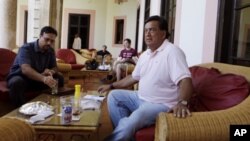 Former New Mexico Gov. Bill Richardson, right, sits in the Nacional Hotel after a press conference in Havana, Tuesday Sept. 13, 2011