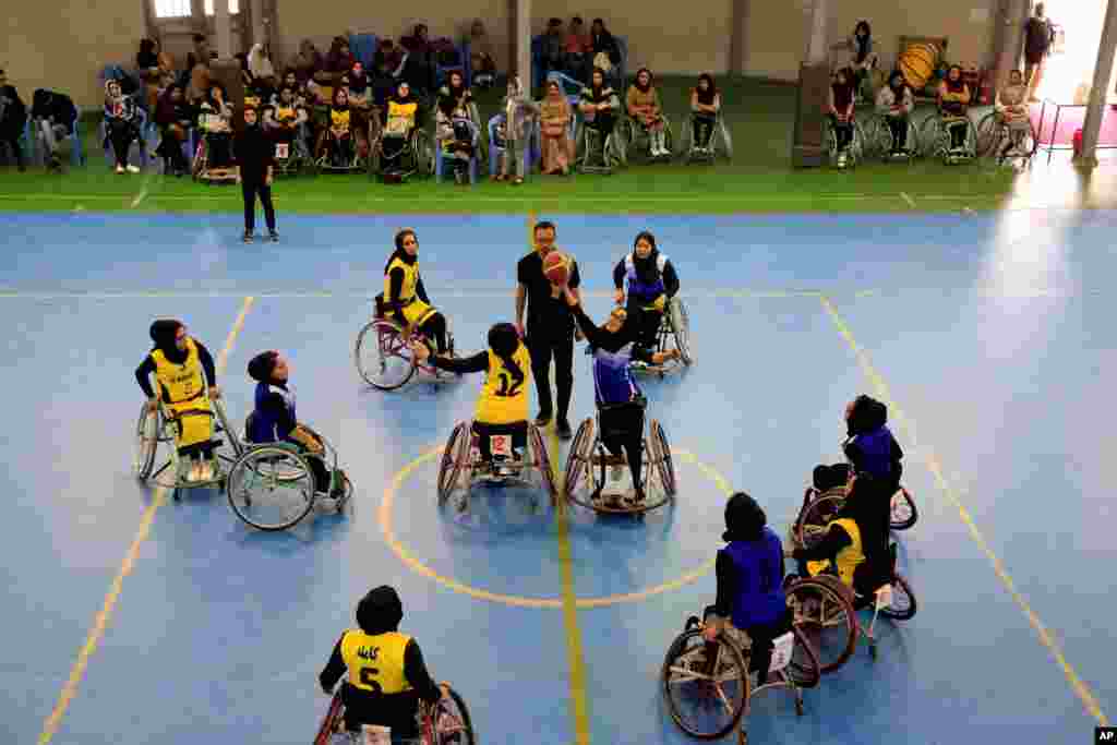 Afghan women participate in a wheelchair basketball match in Kabul, Afghanistan, organized by the International International Committee of the Red Cross.