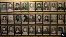 Mug shots of former prisoners hang on the wall at a former prison run by the pre-revolution intelligence service, Savak, now a museum, in downtown Tehran, Jan. 7, 2019. 