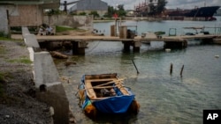 FILE - In this June 29, 2021 file photo, a homemade raft used in an attempt to cross from Cuba to Florida, seized by the Cuban Border Patrol, is moored at the port of Mariel, Cuba. (AP Photo/Ramon Espinosa, File) 