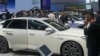 FILE - Visitors look at cars at the BYD booth during the China Auto Show in Beijing, China, Friday, April 26, 2024.