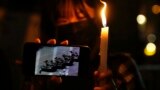 People light candle to mark the anniversary of the military crackdown on a pro-democracy student movement in Beijing, outside Victoria Park in Hong Kong, Friday, June 4, 2021.