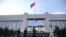 Police patrol at the gate of Kunming's Intermediate Court in Kunming, southwest China's Yunnan province, Sept. 12, 2014.