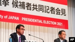 Taro Kono, left, state minister in charge of administrative reform, speaks during a joint news conference as Fumio Kishida, former foreign minister, listens in Tokyo, Sept. 17, 2021. 