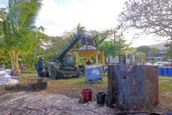 Volunteers handle leaked oil from the bulk carrier ship MV Wakashio, belonging to a Japanese company, which ran aground on a reef, at the Riviere des Creoles, on the Mahebourg waterfront, Mauritius, Aug. 10, 2020.