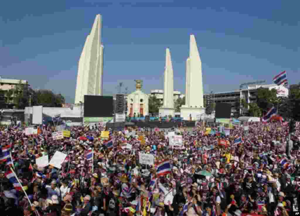 Anti-government protesters gather with national flags during a rally at the Democracy Monument Monday, Jan. 13, 2014, in Bangkok, Thailand. Anti-government protesters took over key intersections in Thailand's capital Monday, halting much of the traffic in
