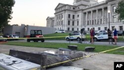 A Ten Commandments monument outside the Arkansas Capitol in Little Rock is blocked off, June 28, 2017, after a motorist hit it with a vehicle, less than 24 hours after its placement on the capitol grounds.